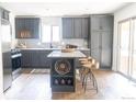 Modern kitchen with gray cabinets, marble countertops, and an island at 476 Devinney Ct, Golden, CO 80401