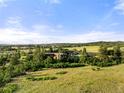 Aerial view of property showing home, grounds and riders on horseback at 3675 S Perry Park Rd, Sedalia, CO 80135