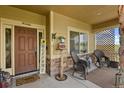 Inviting front porch with rocking chairs and welcoming decor at 28525 Pike View Farm Cir, Elizabeth, CO 80107