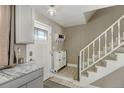 Bright entryway with staircase, coat rack, and shoe storage at 21172 E 45Th Ave, Denver, CO 80249