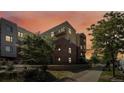 Apartment building with brick and stone exterior, surrounded by landscaping at 3301 Arapahoe Ave # 101, Boulder, CO 80303