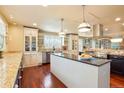 Large kitchen with an island, custom cabinetry, and stainless steel appliances at 5410 Columbine Rd, Denver, CO 80221