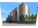 High-rise apartment building with balconies and landscaping at 4570 E Yale Ave # 702, Denver, CO 80222