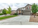 Two-story house with gray siding, red shutters, and a two-car garage at 5052 S Wenatchee Cir, Aurora, CO 80015