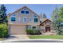 Two-story home with beige siding and attached garage at 114 E 14Th Ct, Broomfield, CO 80020
