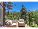 Deck with wicker chairs offering mountain views at 12171 S Critchell Ln, Littleton, CO 80127