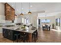Modern kitchen with large island and wood accents at 44035 Pony Express Ct, Elizabeth, CO 80107