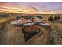 Aerial view of a house with a circular driveway and landscaping at 44035 Pony Express Ct, Elizabeth, CO 80107