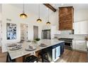Modern kitchen with large island and wood accents at 44035 Pony Express Ct, Elizabeth, CO 80107
