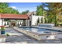 Luxury backyard oasis featuring a stunning pool, spa, and fireplace at 110 N Franklin St, Denver, CO 80218