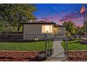 Night view of house with lit windows and American flag at 3790 W 54Th Ave, Denver, CO 80221