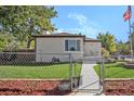 House with chain link fence and American flag at 3790 W 54Th Ave, Denver, CO 80221