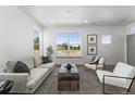 Living room featuring a comfortable couch and chairs at 18633 Stroh Rd # 1-102, Parker, CO 80134