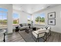 Bright living room with large windows and modern furniture at 18633 Stroh Rd # 1-102, Parker, CO 80134