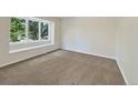 Bright bedroom with neutral walls and carpet, featuring a large bay window at 7264 Siena Way # C, Boulder, CO 80301