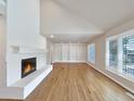 Spacious living room with hardwood floors, built-in shelving, and a cozy fireplace at 7264 Siena Way # C, Boulder, CO 80301