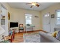 Bright living room with hardwood floors, sofa, and vintage chair at 2660 Utica St, Denver, CO 80212