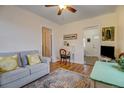Open living area with hardwood floors, sofa, and writing desk at 2660 Utica St, Denver, CO 80212