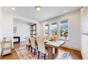 Bright dining room with large windows and rustic table at 9377 Iron Mountain Way, Arvada, CO 80007