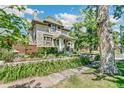 Stone house with lush landscaping and a sidewalk at 3359 Alcott St, Denver, CO 80211