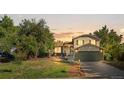 Two-story house with a green garage door and well-maintained landscaping at 15819 E Tennessee Ave, Aurora, CO 80017