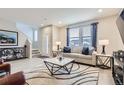 Spacious living room with hardwood floors, neutral color palette, and ample natural light at 6621 N Ceylon St, Denver, CO 80249