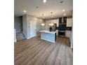 Modern kitchen with island, stainless steel appliances, and light wood flooring at 27472 E 1St Ave, Aurora, CO 80018