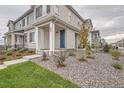 Two-story townhouse with gray and white brick exterior, front entry and landscaping at 27472 E 1St Ave, Aurora, CO 80018