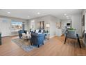 Open-concept living area with stylish furnishings and a view to the kitchen and dining area at 2950 N Steele St, Denver, CO 80205