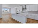 Modern kitchen with white cabinets and island at 3452 N Gold Bug Ct, Aurora, CO 80019