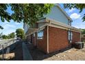 Back exterior showcasing brick, siding, and AC unit at 4463 Adams St, Denver, CO 80216