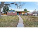 Brick ranch home with covered porch and walkway at 6765 S Adams Way, Centennial, CO 80122