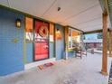 Inviting front porch with red door and wood accents at 6765 S Adams Way, Centennial, CO 80122