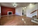 Bright living room featuring hardwood floors, a fireplace, and access to backyard at 19093 E Bellewood Dr, Aurora, CO 80015