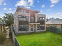 Modern three-story home with stone exterior and landscaped yard at 2010 Irving St, Denver, CO 80211