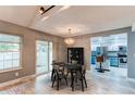 Bright dining room with glass-top table and kitchen views at 2790 S Wheeling Way, Aurora, CO 80014