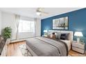 Bright bedroom with large window, hardwood floors, and a king-size bed at 1375 N Williams St # 204, Denver, CO 80218