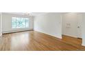 Bright living room featuring hardwood floors and large window at 1375 N Williams St # 204, Denver, CO 80218