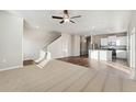 Open living room and kitchen with hardwood and carpeted floors at 2974 Oxley St, Strasburg, CO 80136