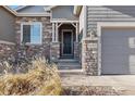 Stone accents and a welcoming porch add charm to the home entrance at 3153 Eagle Claw Pl, Castle Rock, CO 80108