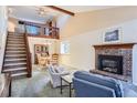 Living room features a fireplace, vaulted ceiling, and loft area at 5894 S Oak St, Littleton, CO 80127