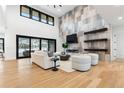 Bright living room with fireplace, hardwood floors, and sliding glass doors leading to deck at 8071 Paradiso Ct, Littleton, CO 80125