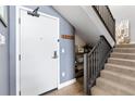 Bright entryway with modern staircase and built-in shelving at 1898 S Bannock St # 504, Denver, CO 80223