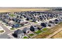 Aerial view of a neighborhood with many houses, showing a large community at 45780 Silverdrop Ave, Bennett, CO 80102