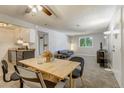 Bright dining area with wood table and chairs, adjacent to kitchen and living room at 16359 W 10Th Ave # W4, Golden, CO 80401