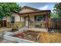 House exterior with stone accents, small front yard, and wooden fence at 643 Tennyson St, Denver, CO 80204