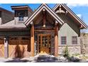 Home exterior with a wooden front door and stone accents at 40 Cooney Ct, Breckenridge, CO 80424