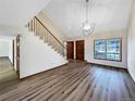 Spacious living room with hardwood floors and a grand staircase at 12436 Columbine Way, Thornton, CO 80241