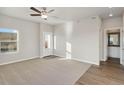 Spacious living room with carpeted floor and access to a bathroom at 3012 Oxley St, Strasburg, CO 80136
