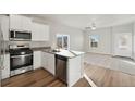 Modern kitchen with stainless steel appliances and light wood flooring at 3012 Oxley St, Strasburg, CO 80136